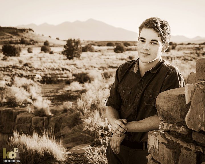 Senior portrait near ruins with the San Francisco Peaks in the background, north of Flagstaff, AZ