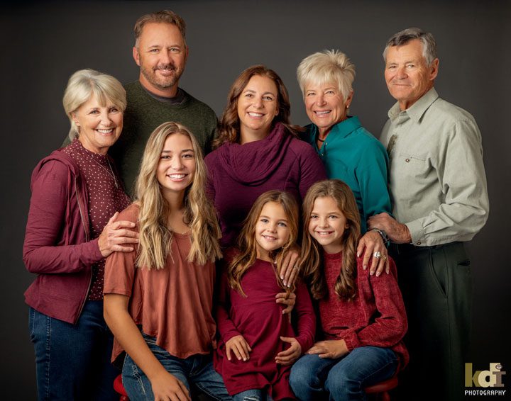 Studio portrait of 3 generations of extended family, laughing in family photos, Flagstaff