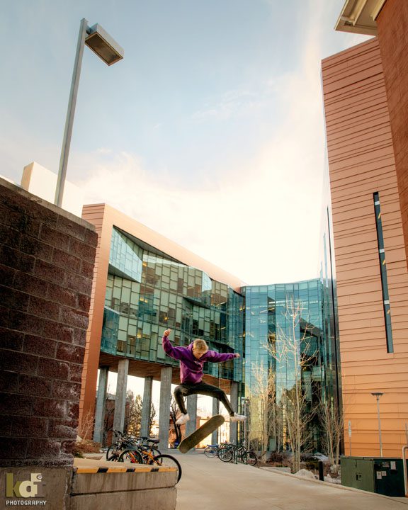 BASIS Flagstaff class of 2021 senior photos, portrait of senior doing a jump on campus at NAU