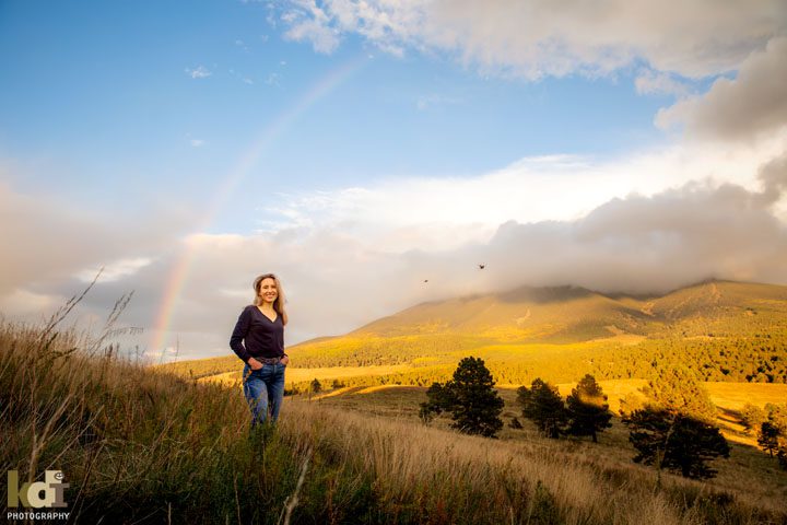 Senior portrait of girl, birds and rainbow in front of the San Francisco Peaks, Flagstaff AZ
