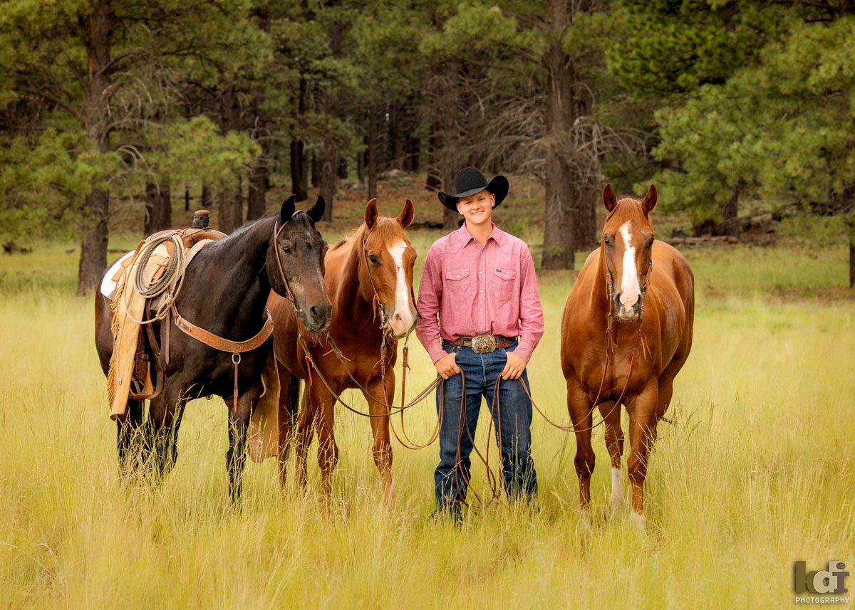 Senior photo of cowboy on with three horses in the forest near Flagstaff, AZ, KDI Photography