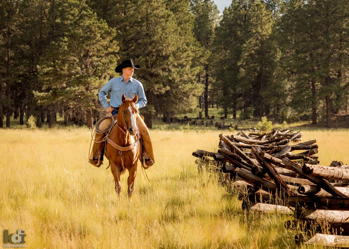 Senior portrait of cowboy on horseback riding in the forests of Flagstaff, AZ, KDI Photography