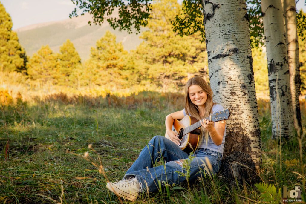 High School Senior Portrait of Girl Wearing Blue, Playing Guitar in Flagstaff, AZ by KDI Photography