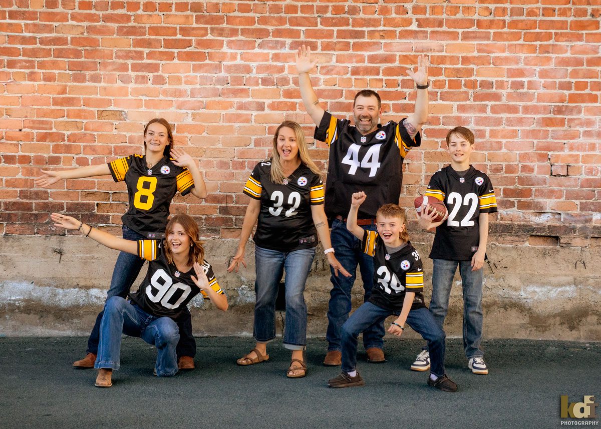 Portrait of family of six, posing hilariously in their Pittsburgh Steelers shirts, Downtown Flagstaff, AZ Portraits by KDI Photography