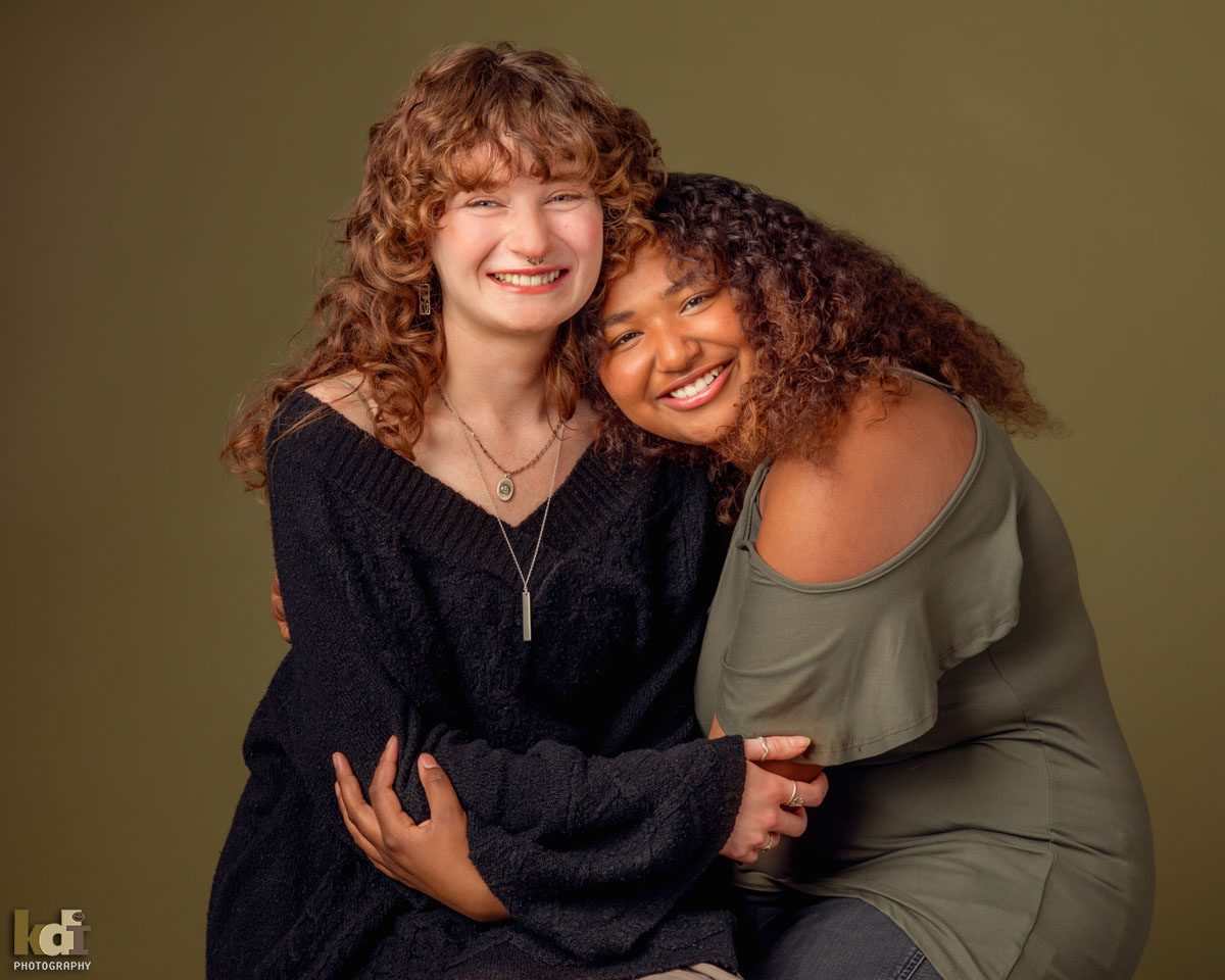 Two Sisters Hugging in Studio Portrait in Flagstaff, AZ by KDI Photography, Flagstaff Family Photographer