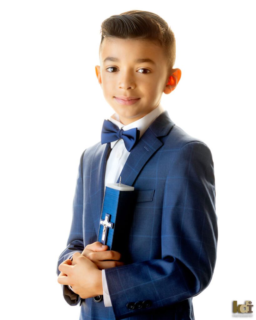 Studio Portrait of Boy Holding Candle With Cross in First Communion Attire, KIds and Family Photos in Flagstaff, AZ © KDI Photography