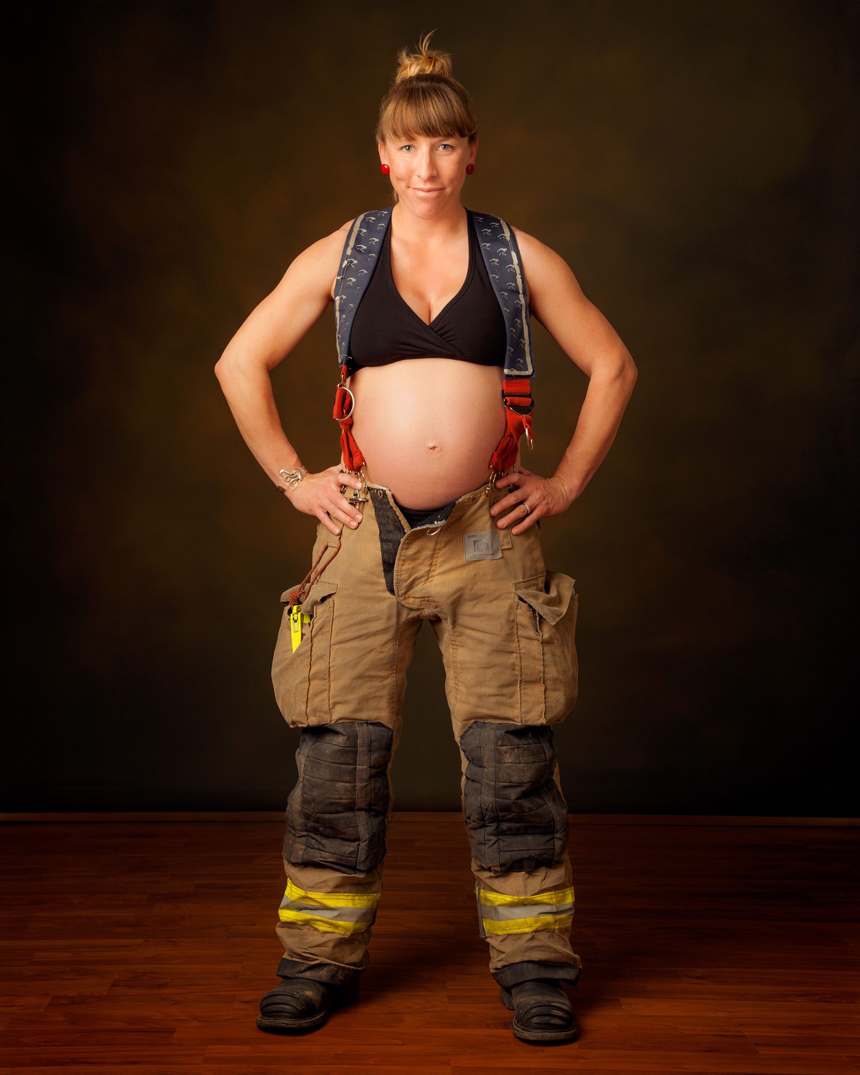 Pregnant Firefighter, in Studio Portrait, Showing her Pregnant Belly, Studio Maternity Portrait in Flagstaff AZ. ©