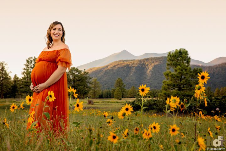 Summer Maternity Photos in Flagstaff with an Expecting Mother in Orange Dress with the San Francisco Peaks in the Background, by Flagstaff Pregnancy Photographer, KDI Photography