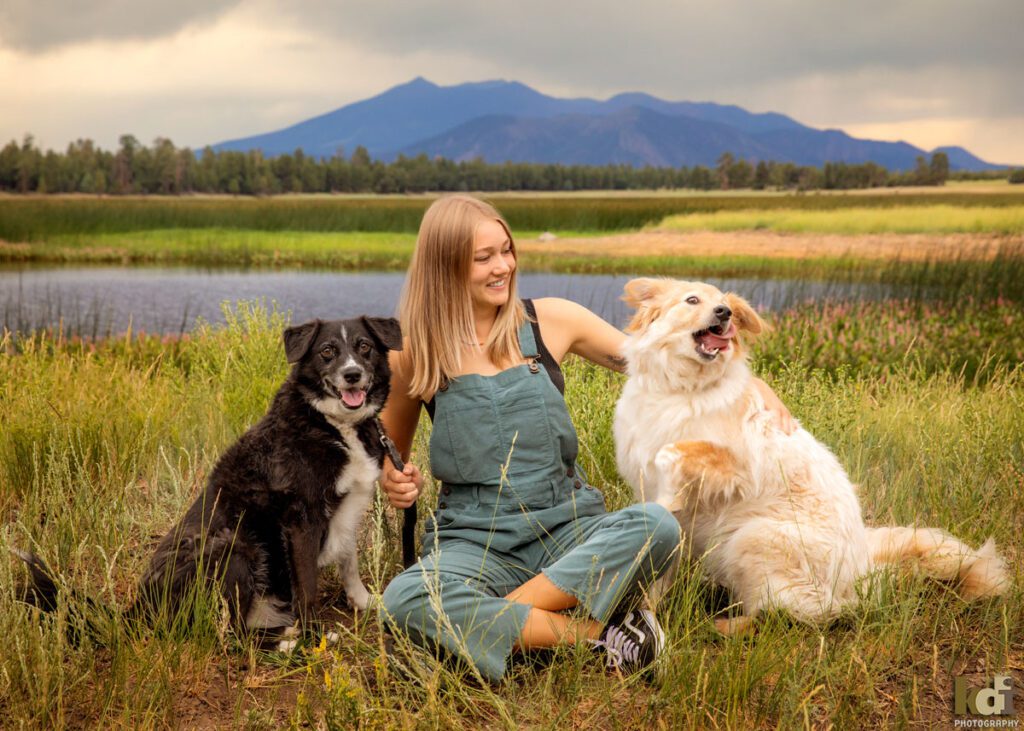 High School Senior Photos of a Girl in Overalls Near a Northern Arizona Lake, with Dogs and Beautiful Flowers, By KDI Photography in Flagstaff, AZ