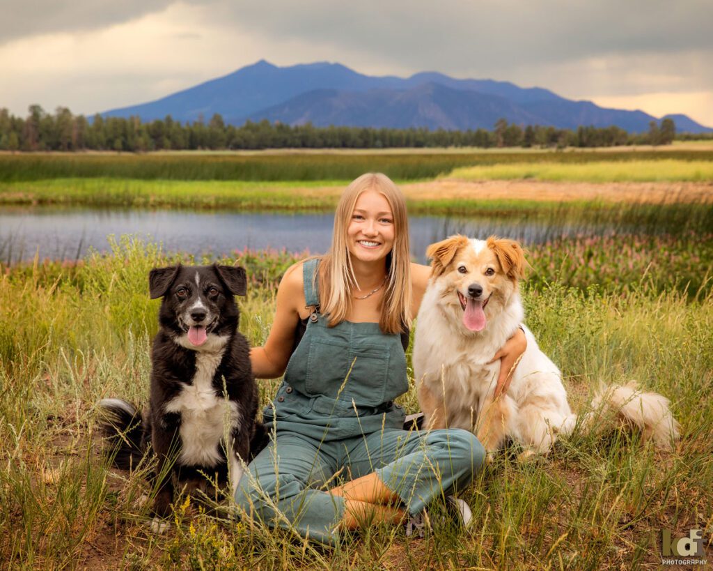 High School Senior Photos of a Girl in Overalls Near a Northern Arizona Lake, with Dogs and Beautiful Flowers, By KDI Photography in Flagstaff, AZ