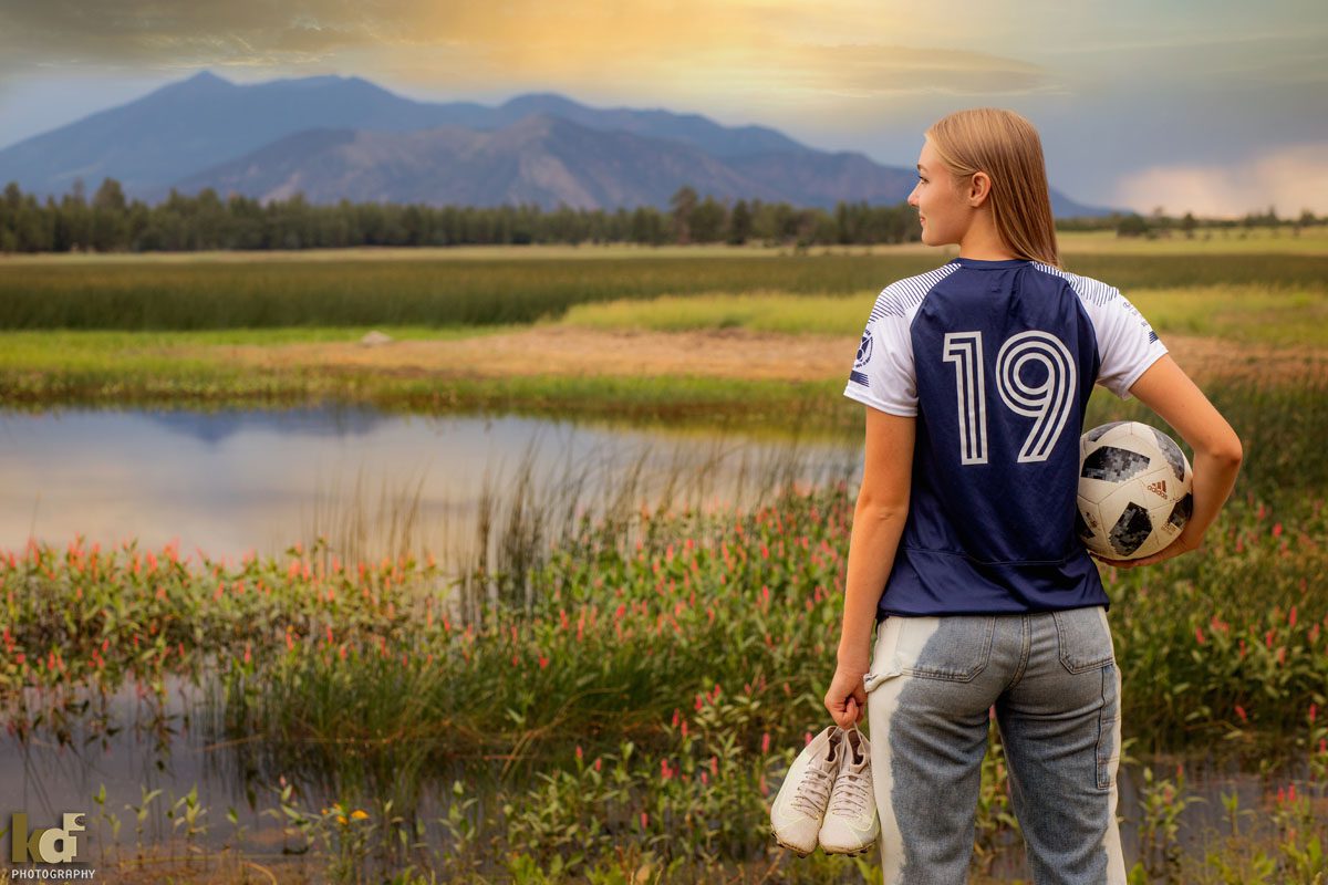 High School Senior Photos of a Soccer Player Near a Northern Arizona Lake, with Beautiful Flowers, By KDI Photography in Flagstaff, AZ