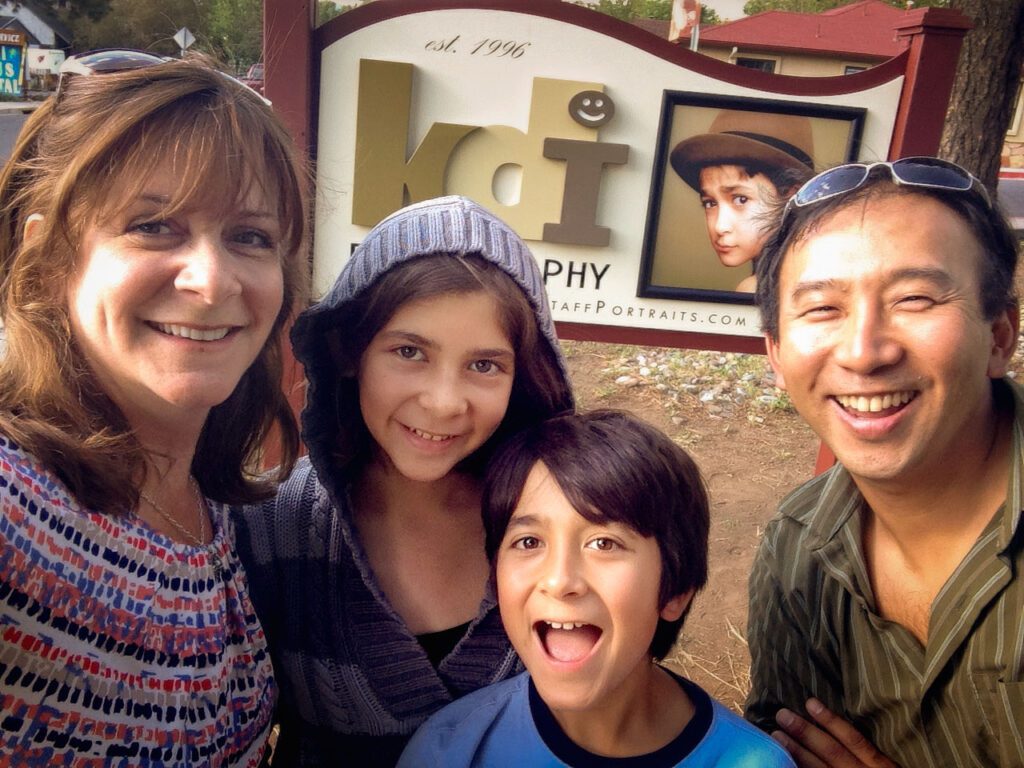 Flagstaff Portraits business owners stand in front of the new KDI Photography studio sign in 2014.