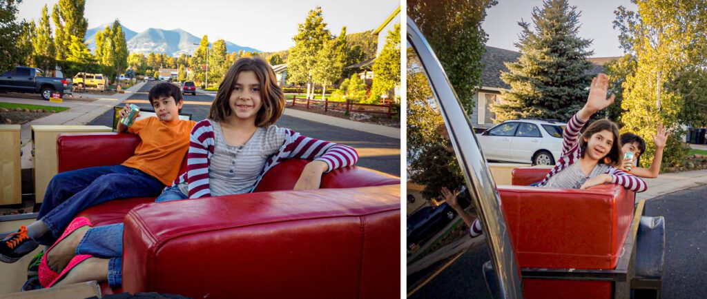 Kids sit in red couch on back of moving truck on Flagstaff photo studio moving day, KDI Photography, Fagstaff