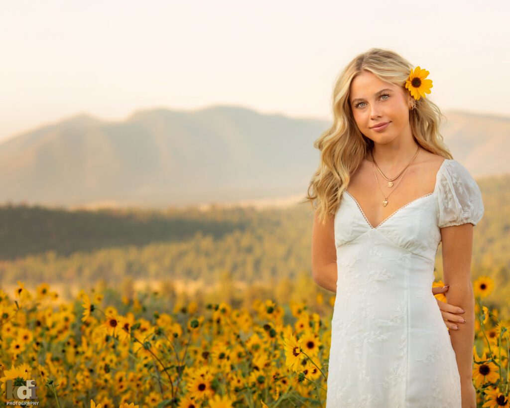 Senior Photos of a Girl in White Dress in a Field of Sunflowers with the San Francisco Peaks of Northern Arizona in the Background, Location Portraits by KDI Photography