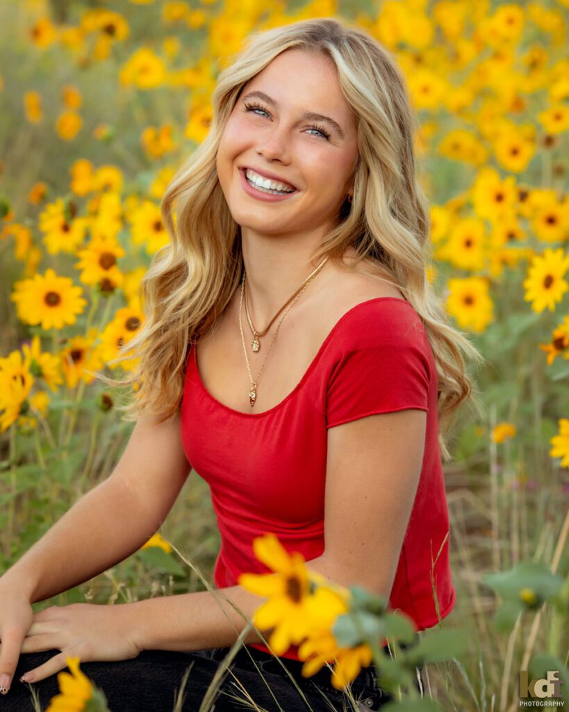 Senior Portrait of a Laughing Girl in Red Shirt in a Field of Wildflowers Outside of Flagstaff, AZ, Location Portraits by KDI Photography