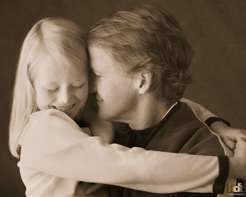 Portrait of a father, snuggling his giggling tween preteen daughter, studio family pictures in Northern Arizona, family photographs by KDI Photography
