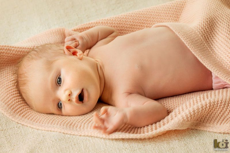 Color baby photo of a newborn baby in pink blanket, studio portraits in Northern Arizona, family portraits by KDI Photography