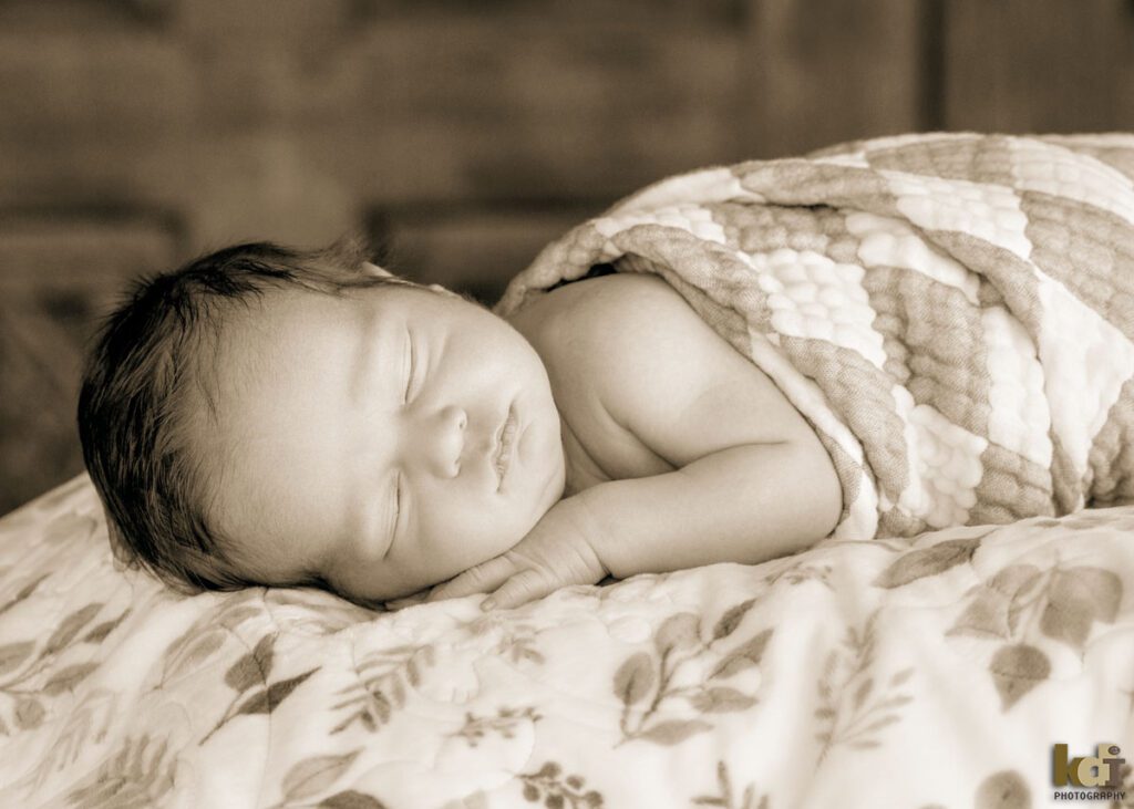 Black and white newborn photography, portrait of a new baby boy, lying on blanket asleep, in a photo studio in Flagstaff by newborn and family photographer, KDI Photography
