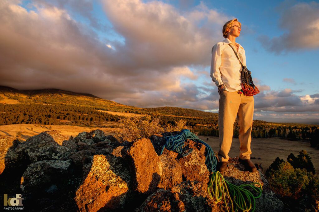 Portrait a rock climber, senior photos of a senior boy in a white shirt, in the mountains of Flagstaff, by family portrait artist, KDI Photography