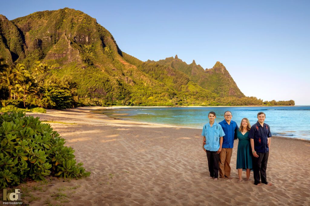 Family portraits of a husband, wife and two teen boys, on a beach in Hawaii, location family photos by Flagstaff photographers KDI Photography.