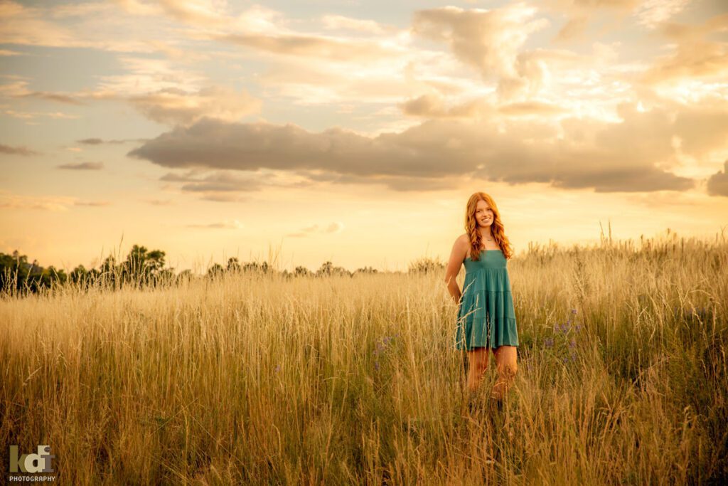 High school senior photos showing girl with red hair and green dress in a meadow in Northern Arizona, portrait photography in Flagstaff AZ by senior photographer KDI Photography

