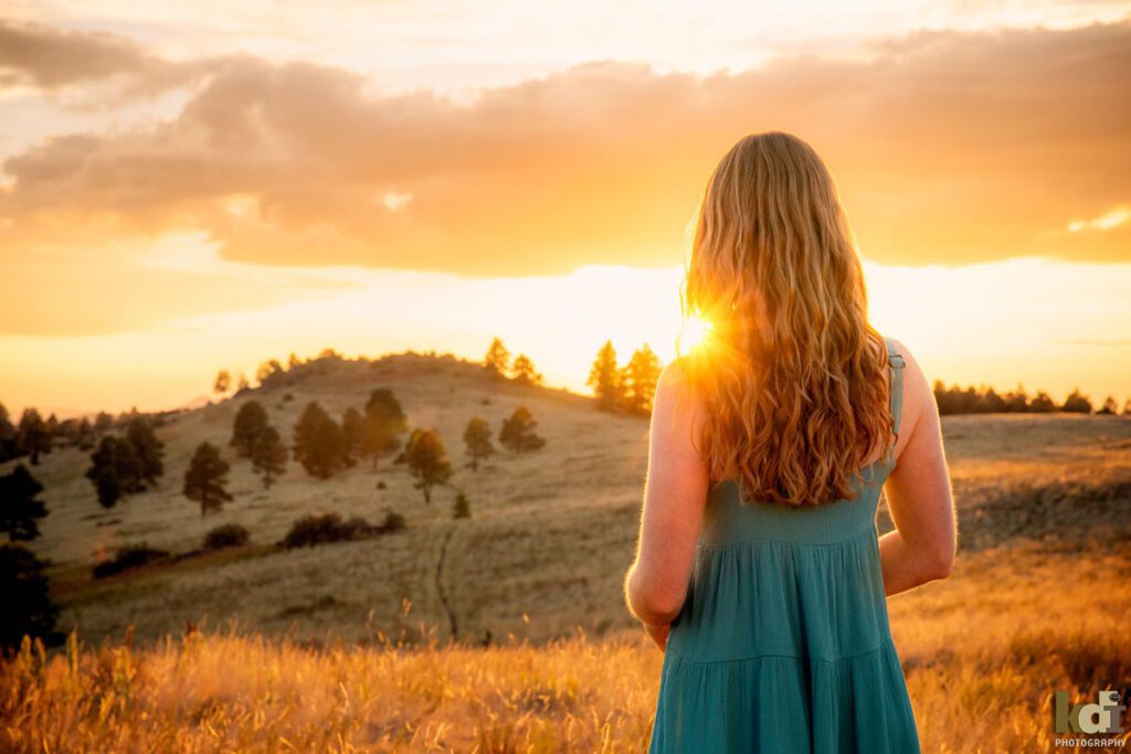 High school senior photos showing girl with red hair, looking at the sunset, Northern Arizona, portrait photography in Flagstaff AZ by senior photographer KDI Photography