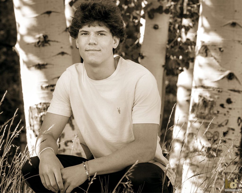 Black and white portrait of a senior boy in the aspens of Northern Arizona,, senior photos on location in the San Francisco Peaks, by Flagstaff photographer, KDI Photography.